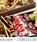 A multi-sensory charcuterie board featuring premium sliced salami, prosciutto 138613118