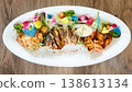 A multi-sensory seafood platter featuring grilled fish steaks and salmon 138613134