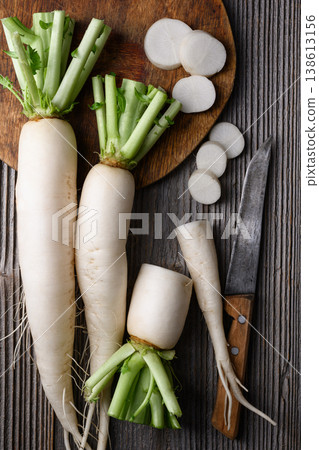 Daikon radish arranged on wooden board with slices Daikon radish arranged on wooden board with slices 138613156