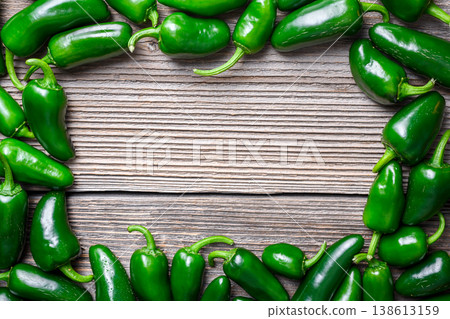 Frame made of jalapeno peppers on wooden background Frame made of jalapeno peppers on wooden background 138613159