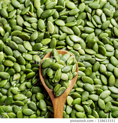 Pumpkin seeds on spoon and background Pumpkin seeds on spoon and background 138613331
