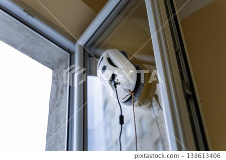 Close up of a White Window Cleaning Robot Working on Glass 138613406