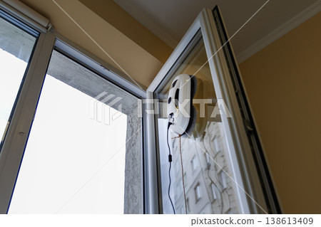 Automatic Window Cleaning Robot Working on an Open Glass Door Automatic Window Cleaning Robot Working on an Open Glass Door 138613409