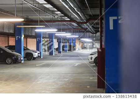 Interior of a modern underground parking lot with cars 138613438