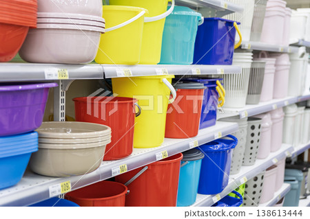 Colorful plastic buckets on supermarket shelves with visible price tags 138613444