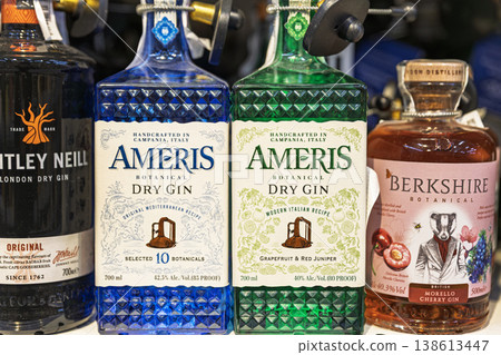 Premium gin and cognac bottles with security tags on supermarket shelf Premium gin and cognac bottles with security tags on supermarket shelf 138613447