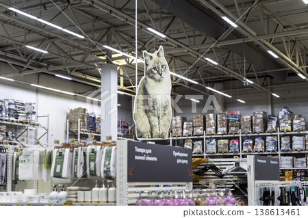 Cat-shaped signage hanging in a supermarket. Cat-shaped signage hanging in a supermarket. 138613461