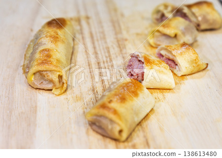 Delicious Pan-Fried Crepe Rolls with Minced Meat Filling on Wood Delicious Pan-Fried Crepe Rolls with Minced Meat Filling on Wood 138613480
