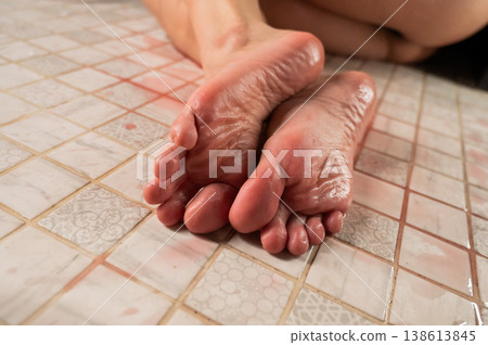 Foot fetish. A woman pours wine on her feet. Foot fetish. A woman pours wine on her feet. 138613845