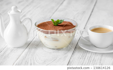 Classic Italian tiramisu dessert in glass bowl with espresso and milk jug Classic Italian tiramisu dessert in glass bowl with espresso and milk jug 138614126