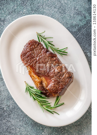 Perfectly grilled beef steak with rosemary on white plate premium restaurant presentation 138614130