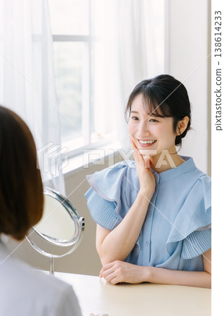 A woman receiving a consultation at a cosmetic surgery clinic. A woman receiving a consultation at a cosmetic surgery clinic. 138614233