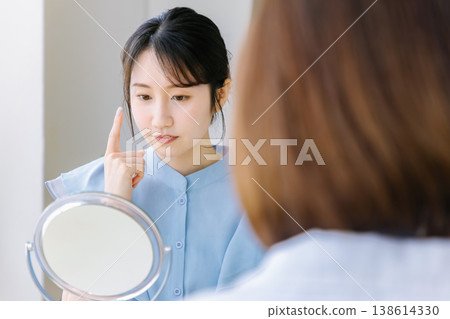 A woman receiving a consultation at a cosmetic surgery clinic. 138614330
