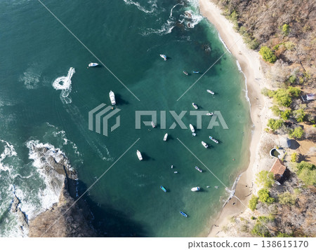 Boats gather near shore in a quiet bay during daytime Boats gather near shore in a quiet bay during daytime 138615170
