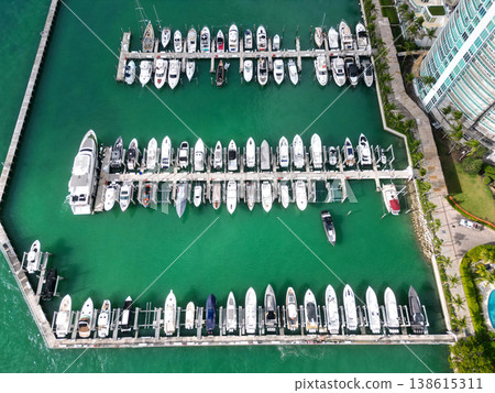 Luxury marina with private yacht and boat. Docked yacht boat in harbor. Luxury summer vacation in Miami. Private boat top view. Marina and luxury sea boat. Yacht club and marina in Miami. Busy marina Luxury marina with private yacht and boat. Docked yacht boat in harbor. Luxury summer vacation in Miami. Private boat top view. Marina and luxury sea boat. Yacht club and marina in Miami. Busy marina 138615311