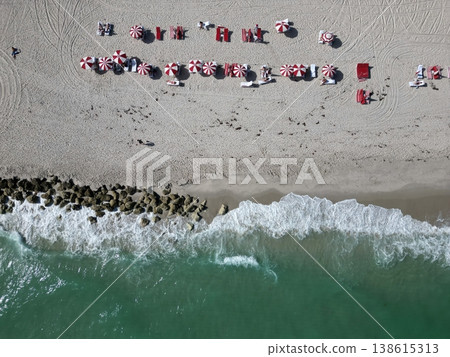 Summer vacation in paradise. Beach vacation at sea in summer. Sea relax under beach umbrella. Travel to sea. Aerial top view of sand beach with crystal clear turquoise water. Enjoying beach sun 138615313