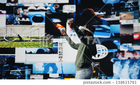 VR headset gear used by person to look at internet video channels, isolated over digital backdrop. Woman enjoying unlimited metaverse video content using virtual reality tech, camera A VR headset gear used by person to look at internet video channels, isolated over digital backdrop. Woman enjoying unlimited metaverse video content using virtual reality tech, camera A 138615781