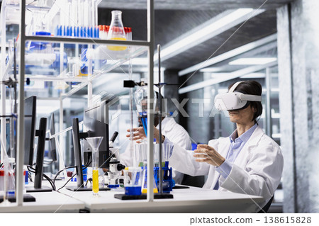 Laboratory bioinformatics scientist evaluates genetic markers associated with disease risk using VR headset gear. Man studies DNA strand mapping with genomics analysis program and virtual reality tech Laboratory bioinformatics scientist evaluates genetic markers associated with disease risk using VR headset gear. Man studies DNA strand mapping with genomics analysis program and virtual reality tech 138615828