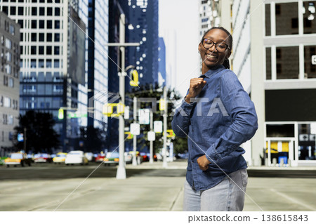 Dancing, good news and exulting woman on city street receiving positive school grade. Raving, high college exam marks and overjoyed african american young girl outside celebrating 138615843