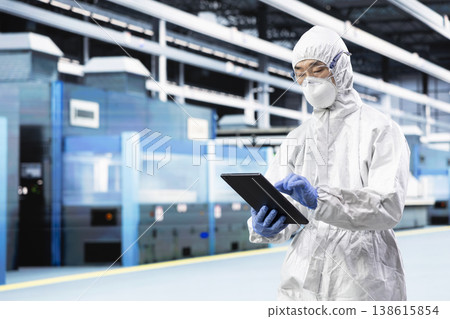 Man walking in automated microchip factory, designing silicon wafers with tablet. Tech professional inspecting semiconductor substrates infrastructure with device, doing quality control Man walking in automated microchip factory, designing silicon wafers with tablet. Tech professional inspecting semiconductor substrates infrastructure with device, doing quality control 138615854