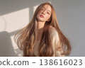 A woman with long, colored hair. 138616023