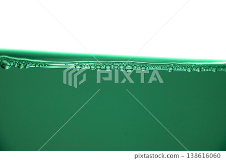 Green liquid surface with air bubbles, clean water texture, macro underwater line, freshness and purity abstract background. Green liquid surface with air bubbles, clean water texture, macro underwater line, freshness and purity abstract background. 138616060