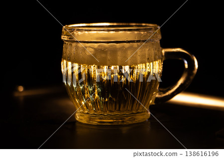 Cold golden beer in glass mug with foam and condensation on dark background, refreshing drink and bar beverage concept. 138616196