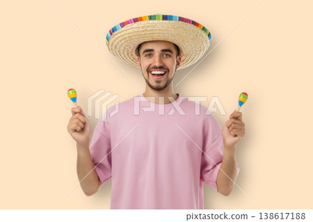 Cinco de Mayo, Man holds maracas and smiles while wearing a large hat Cinco de Mayo, Man holds maracas and smiles while wearing a large hat 138617188