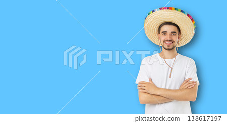 Man smiles and poses in a sombrero for Cinco de Mayo Man smiles and poses in a sombrero for Cinco de Mayo 138617197