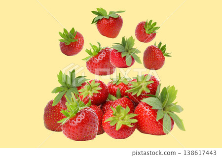 Many red strawberries with green tops show on yellow Many red strawberries with green tops show on yellow 138617443