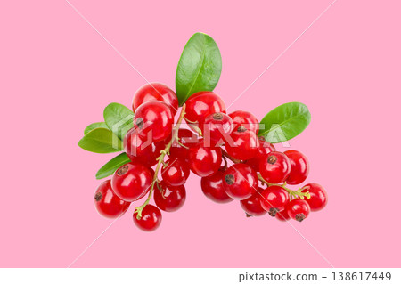 Fresh red berries with green leaves on a light pink surface Fresh red berries with green leaves on a light pink surface 138617449