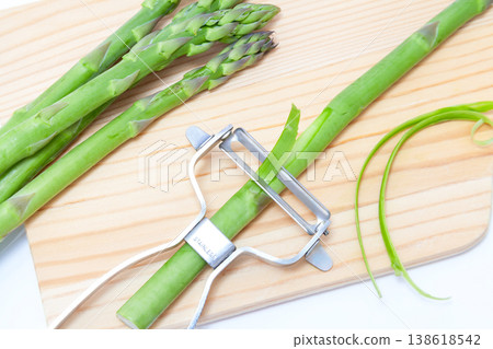 Image of peeling asparagus with an eyelash curler. Image of peeling asparagus with an eyelash curler. 138618542