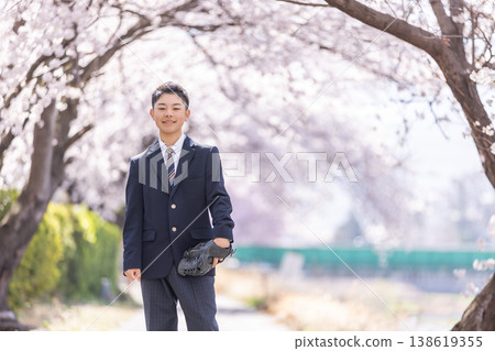High school boy walking along cherry blossom trees High school boy walking along cherry blossom trees 138619355