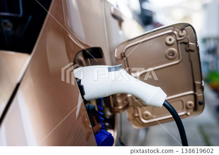 Charging plug connected to an electric vehicle Charging plug connected to an electric vehicle 138619602
