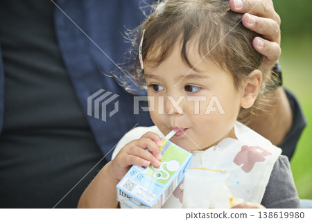 Close-up of a toddler drinking juice 138619980