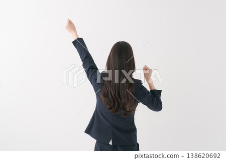 A woman in a suit that makes a guts pose 138620692