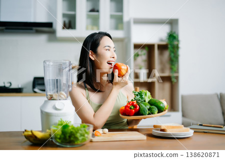 Happy Asian woman holding a plate of fresh vegetables and smiling in a modern kitchen. Concept of healthy lifestyle, clean eating, vegan diet, and organic nutrition Happy Asian woman holding a plate of fresh vegetables and smiling in a modern kitchen. Concept of healthy lifestyle, clean eating, vegan diet, and organic nutrition 138620871