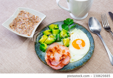 Breakfast: pork, avocado, scrambled eggs and buckwheat Breakfast: pork, avocado, scrambled eggs and buckwheat 138620885