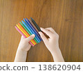 A child's hand holding a colored pen 138620904