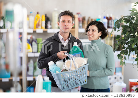 Couple man and woman choosing household chemicals in store Couple man and woman choosing household chemicals in store 138620996