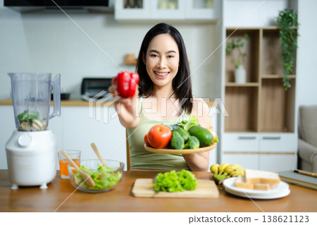 Healthy lifestyle concept of woman enjoying fresh salad and juice at home. Clean eating, nutrition, organic food, wellness, fitness and balanced diet Healthy lifestyle concept of woman enjoying fresh salad and juice at home. Clean eating, nutrition, organic food, wellness, fitness and balanced diet 138621123