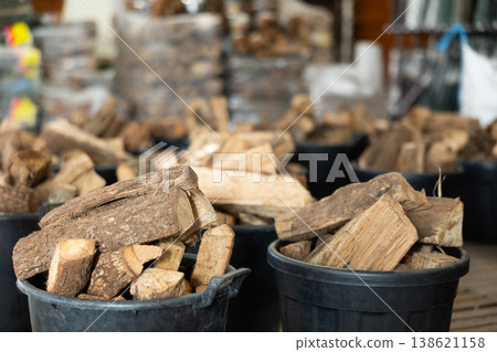 Bundled firewood stacked in buckets at store Bundled firewood stacked in buckets at store 138621158