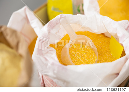 Ground corn in large woven bags in store Ground corn in large woven bags in store 138621197