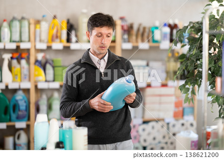 Middle-aged man choosing laundry detergent at department store Middle-aged man choosing laundry detergent at department store 138621200