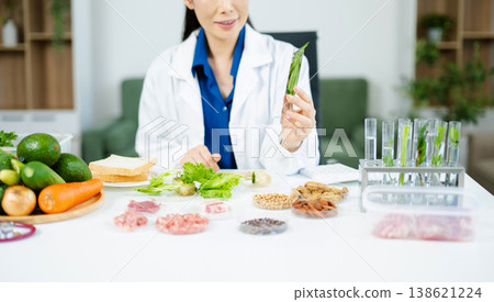 Scientist in a modern lab analyzing food samples with advanced equipment. Perfect for food science, research in  in food science and biotechnology 138621224