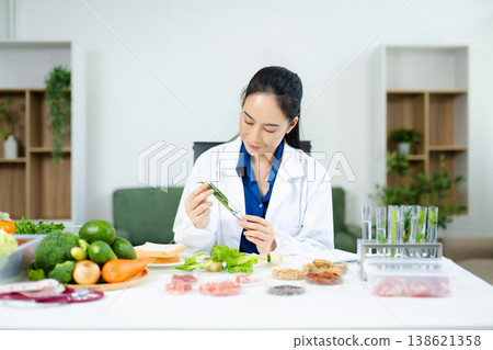 Scientist in a modern lab analyzing food samples with advanced equipment. Perfect for food science, research in  in food science and biotechnology 138621358