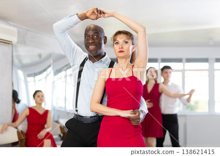 African man and woman dancing waltz in couple during lesson at studio 138621415