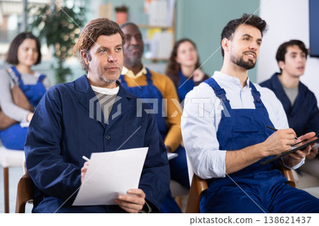 In lecture, staf employee group write on large piece of paper In lecture, staf employee group write on large piece of paper 138621437