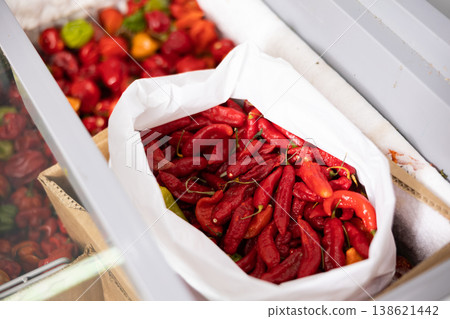 Whole frozen red sweet pepper are in shopwindow refrigerator. Whole frozen red sweet pepper are in shopwindow refrigerator. 138621442