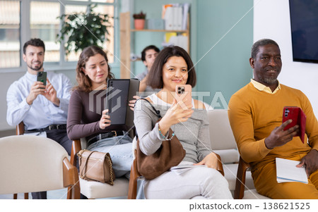 Asian woman participants take photos of presentation slide or scan QR code 138621525